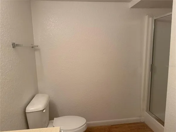 a white toilet sitting next to a shower