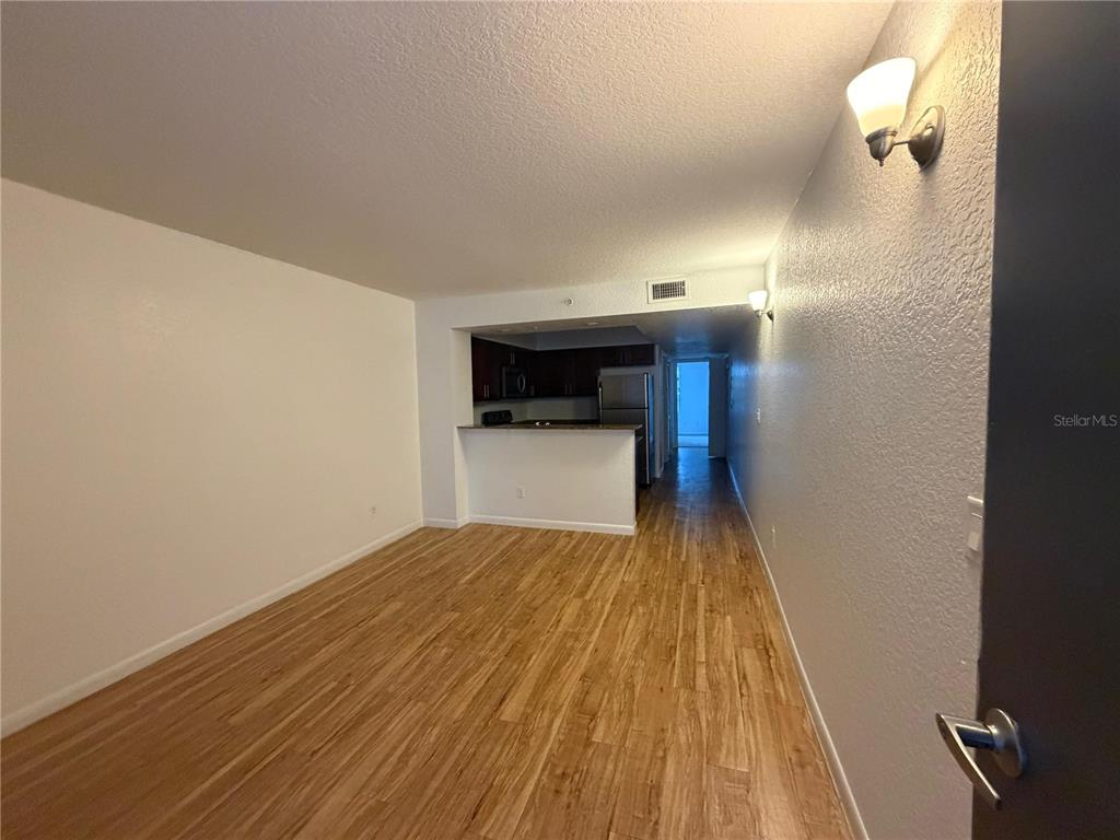 2323 McCoy Road, Unit 815 Orlando, FL 32809 - Photo 5 of 14 a view of empty room with wooden floor