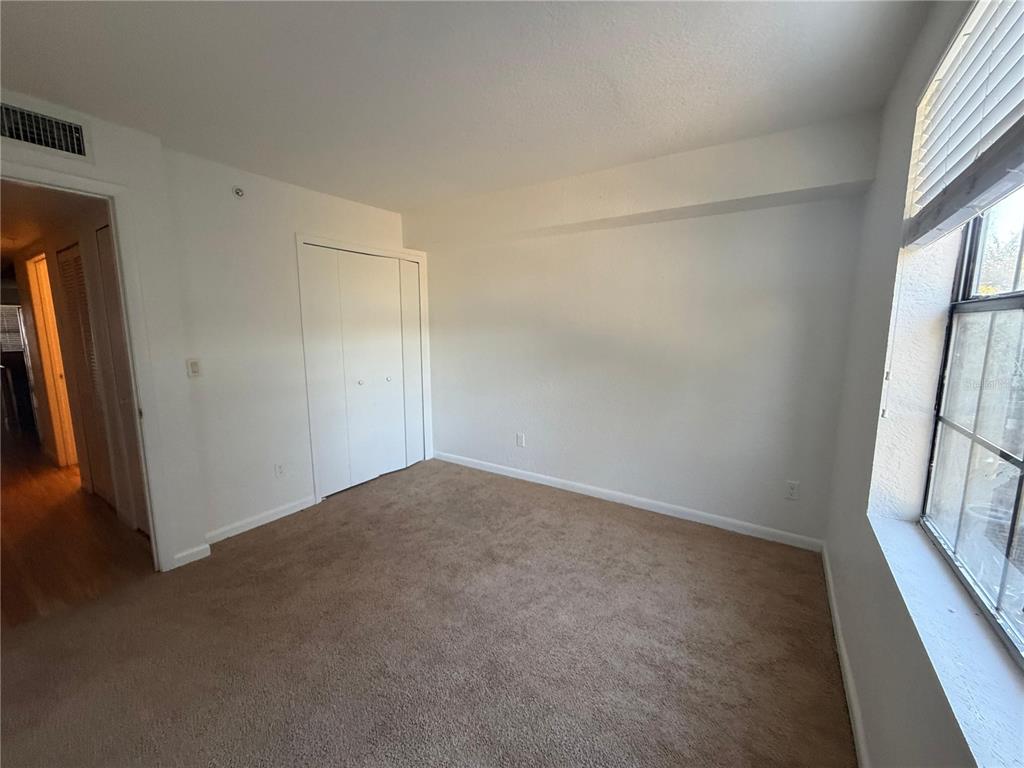 2323 McCoy Road, Unit 815 Orlando, FL 32809 - Photo 9 of 14 an empty room with windows