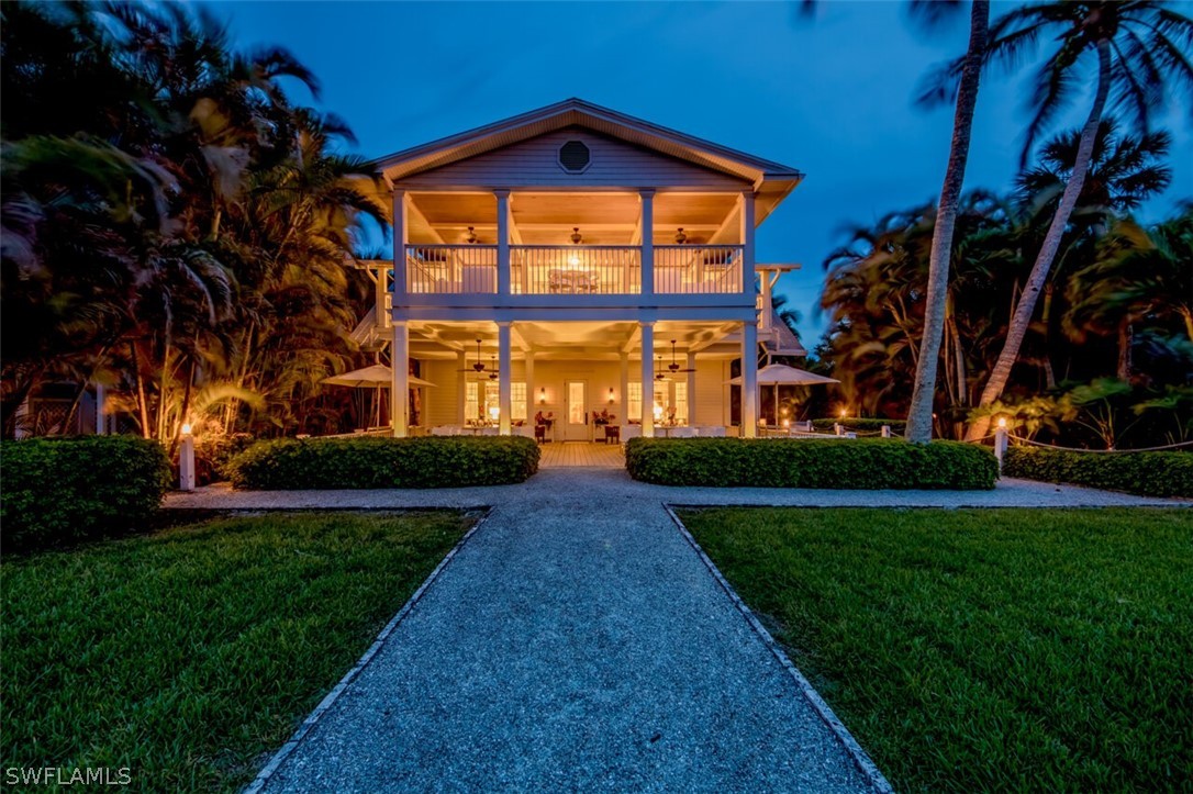 a view of an entrance to house with yard and green space