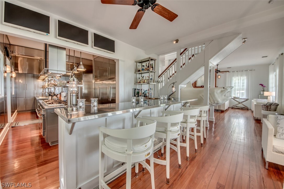 8241 Main Street Bokeelia, FL 33922 - Photo 11 of 35 a living room with furniture and a wooden floor