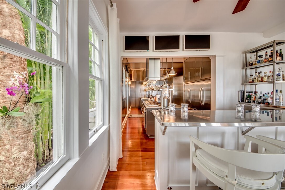 8241 Main Street Bokeelia, FL 33922 - Photo 12 of 35 a living room with furniture and a floor to ceiling window