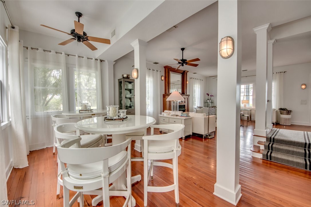 8241 Main Street Bokeelia, FL 33922 - Photo 15 of 35 a view of a dining room with furniture window and wooden floor