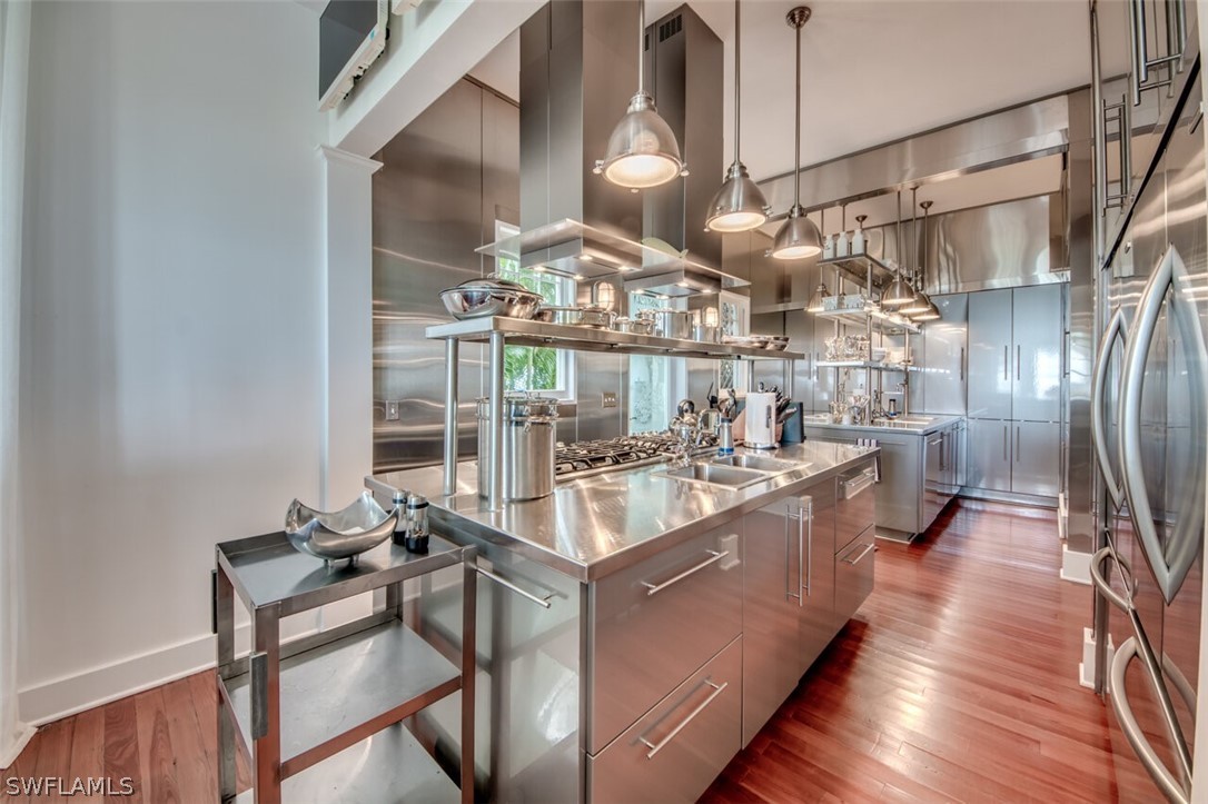 8241 Main Street Bokeelia, FL 33922 - Photo 18 of 35 a kitchen with counter top space and wooden floor