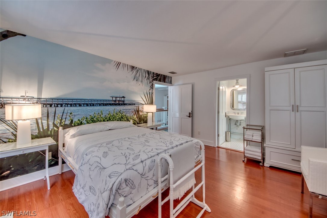 8241 Main Street Bokeelia, FL 33922 - Photo 19 of 35 a bedroom with a bed and a view of kitchen