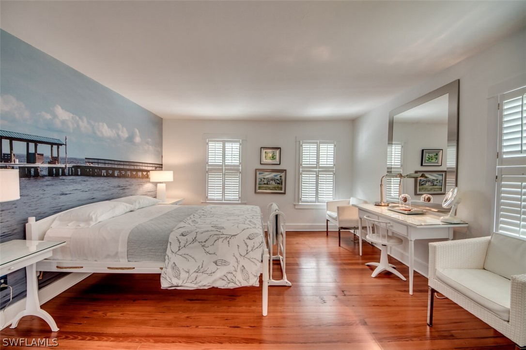 8241 Main Street Bokeelia, FL 33922 - Photo 20 of 35 a living room with furniture and a wooden floor