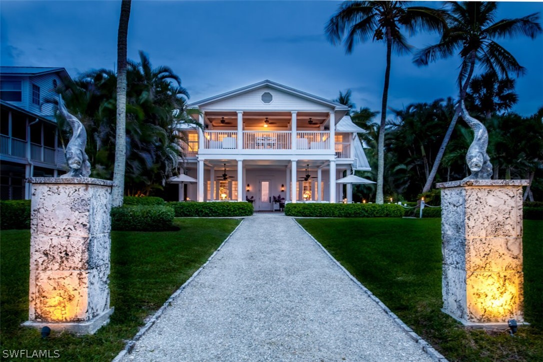 8241 Main Street Bokeelia, FL 33922 - Photo 2 of 35 a front view of a house with garden