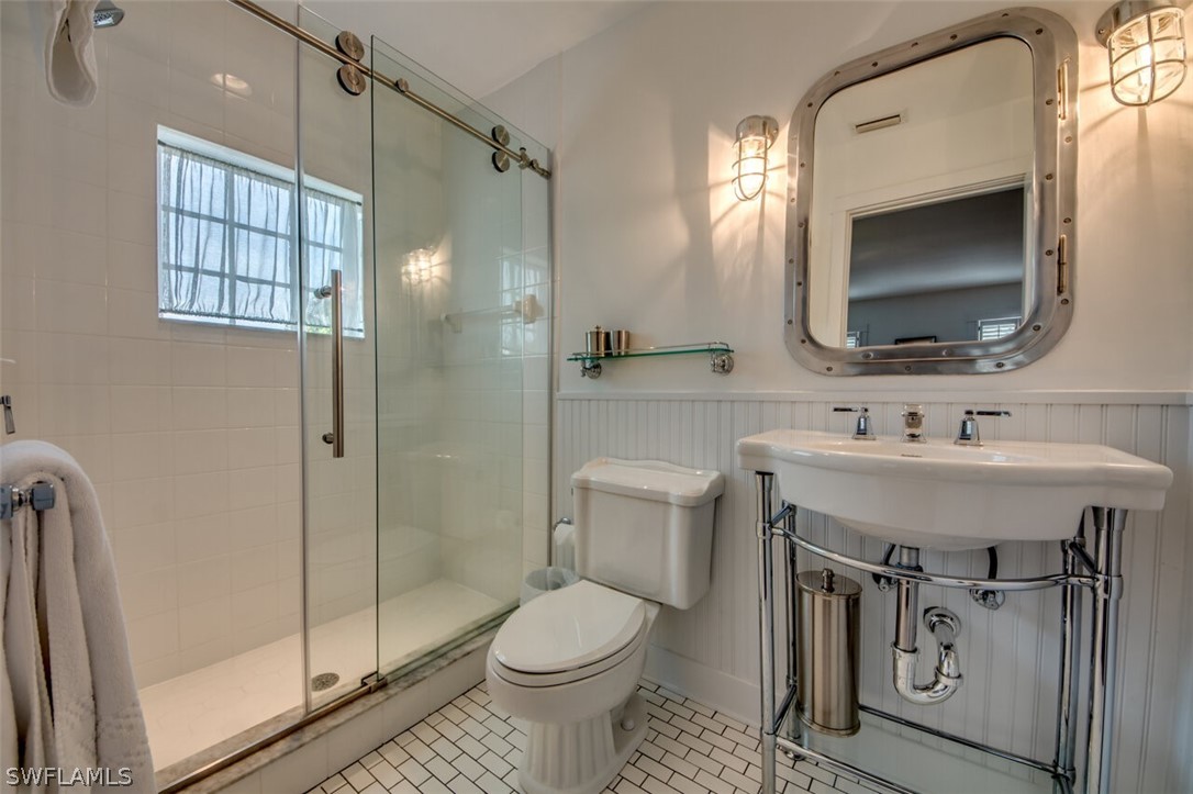 8241 Main Street Bokeelia, FL 33922 - Photo 21 of 35 a bathroom with a sink toilet and shower