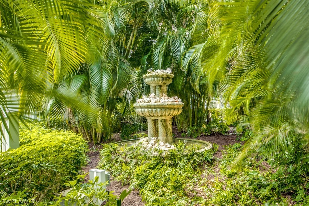 8241 Main Street Bokeelia, FL 33922 - Photo 34 of 35 a view of a garden with a fountain