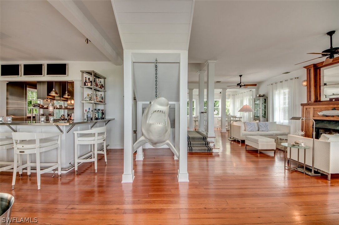 8241 Main Street Bokeelia, FL 33922 - Photo 5 of 35 a living room with fireplace furniture and a wooden floor
