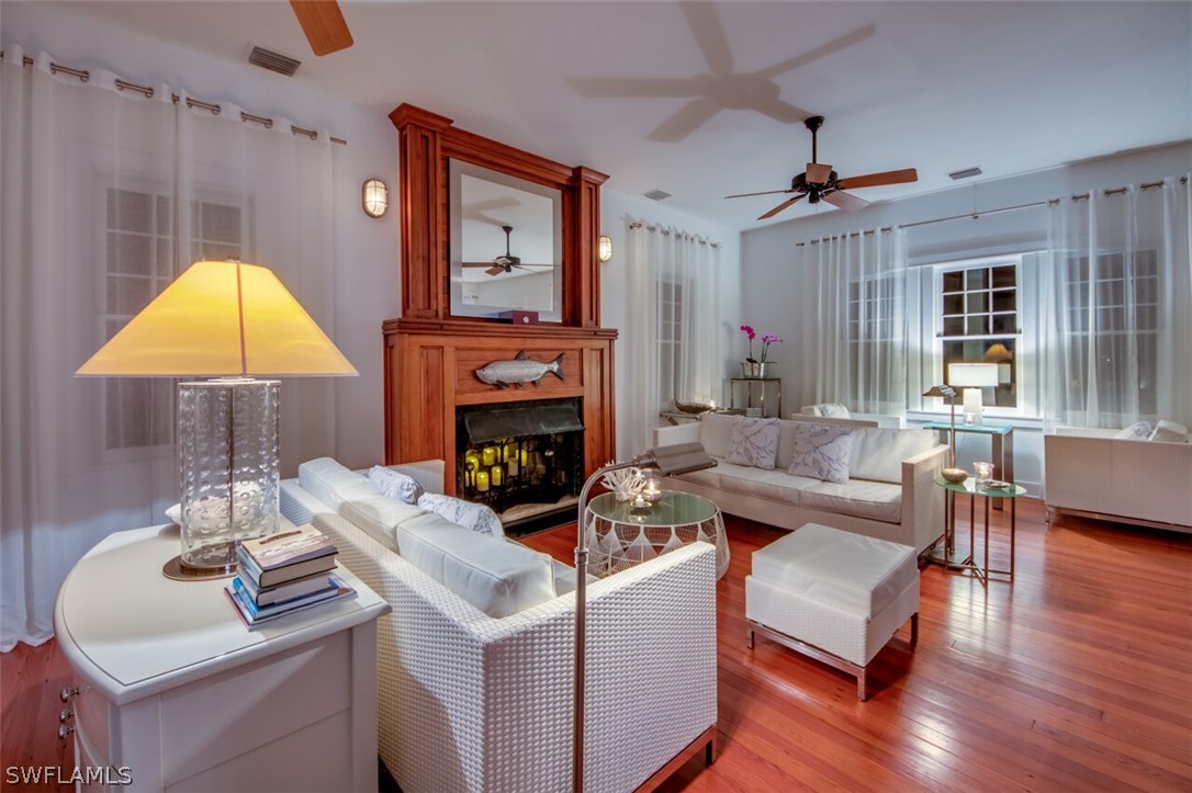 8241 Main Street Bokeelia, FL 33922 - Photo 7 of 35 a living room with furniture a fireplace and a table