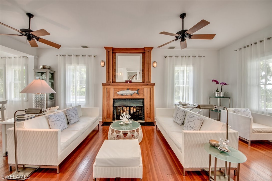 8241 Main Street Bokeelia, FL 33922 - Photo 10 of 35 a living room with furniture and a fireplace