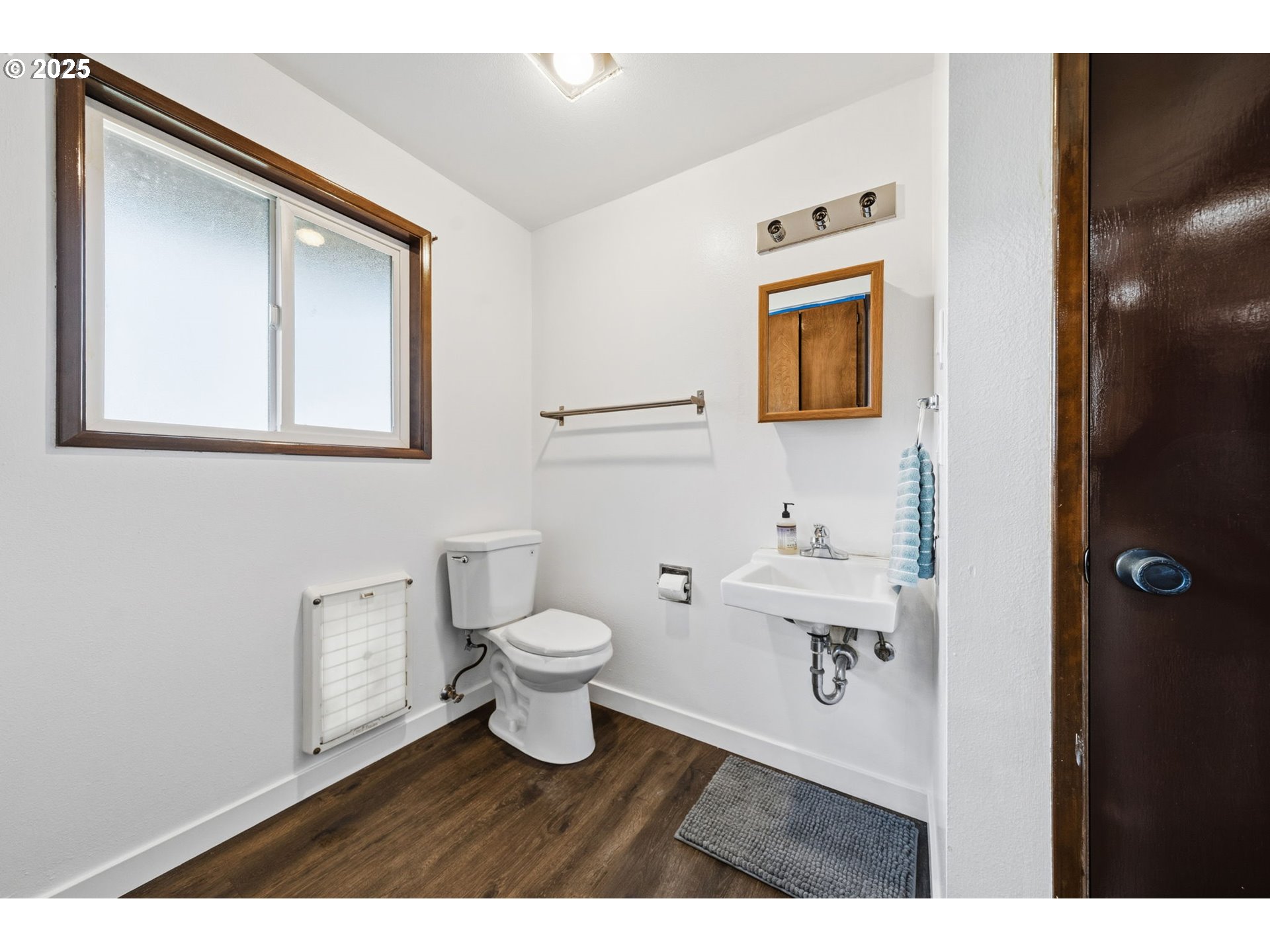 1425 Willamina Avenue Forest Grove, OR 97116 - Photo 13 of 38 a bathroom with a toilet sink a mirror and vanity