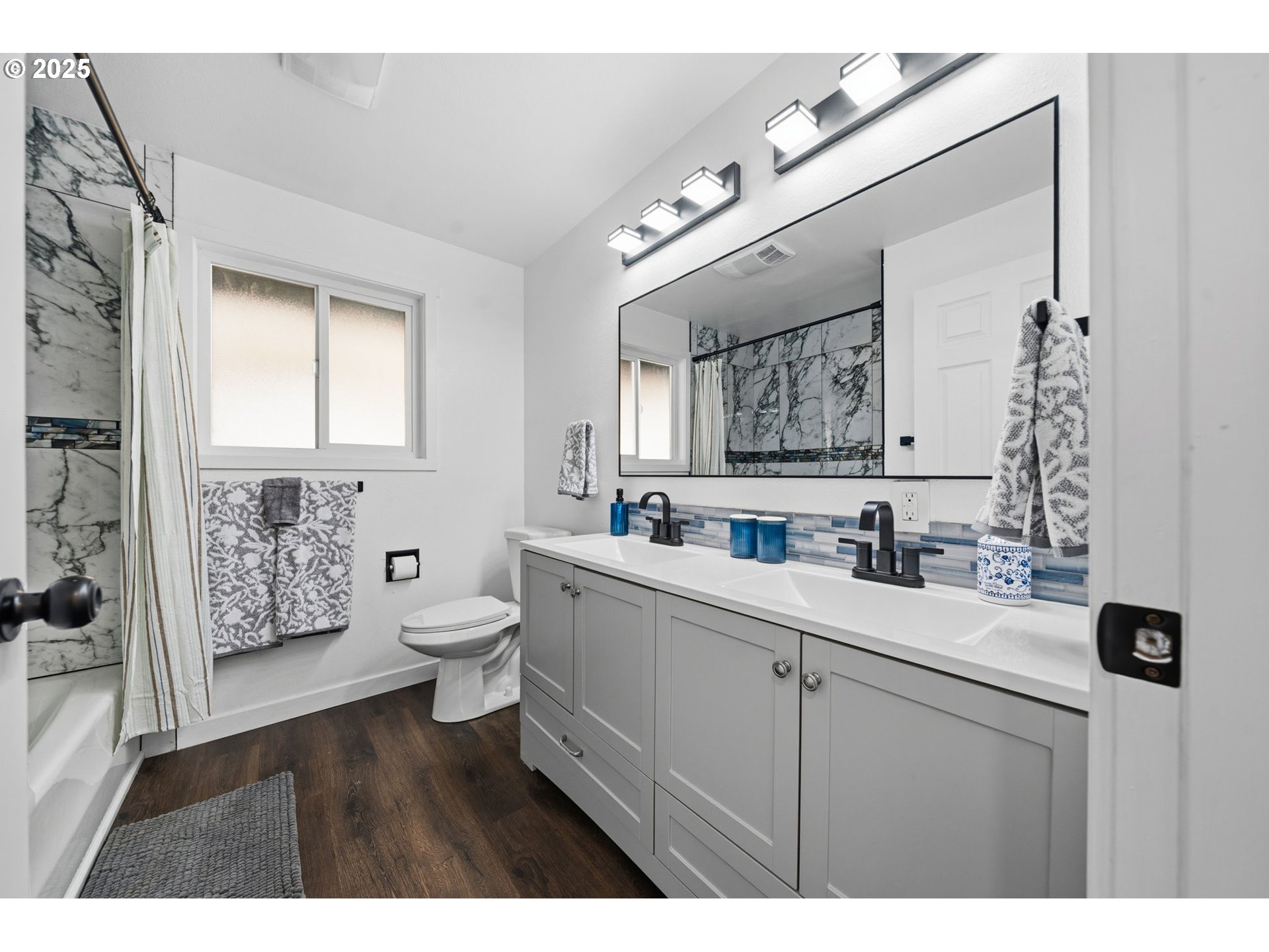 1425 Willamina Avenue Forest Grove, OR 97116 - Photo 14 of 38 a bathroom with a toilet a sink a mirror and a shower