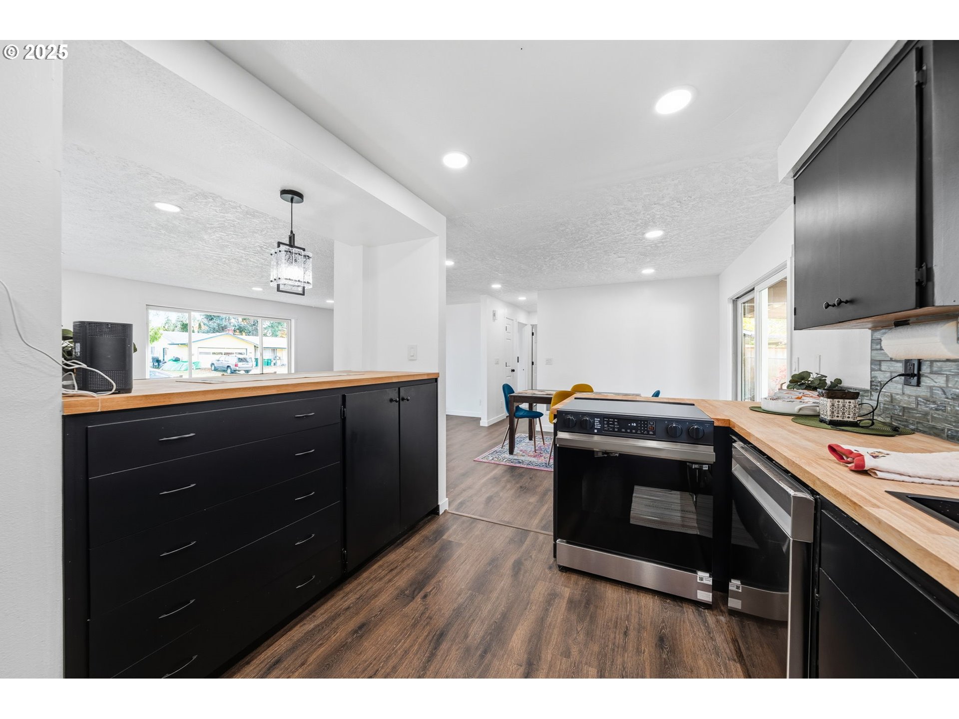 1425 Willamina Avenue Forest Grove, OR 97116 - Photo 6 of 38 a kitchen with stainless steel appliances granite countertop a stove a sink and a microwave