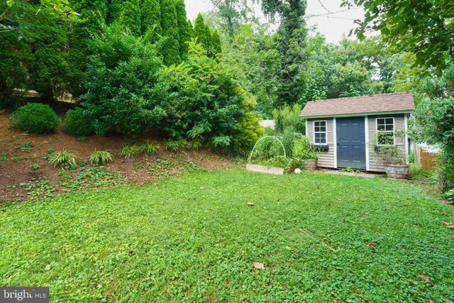a view of a house with yard and a garden