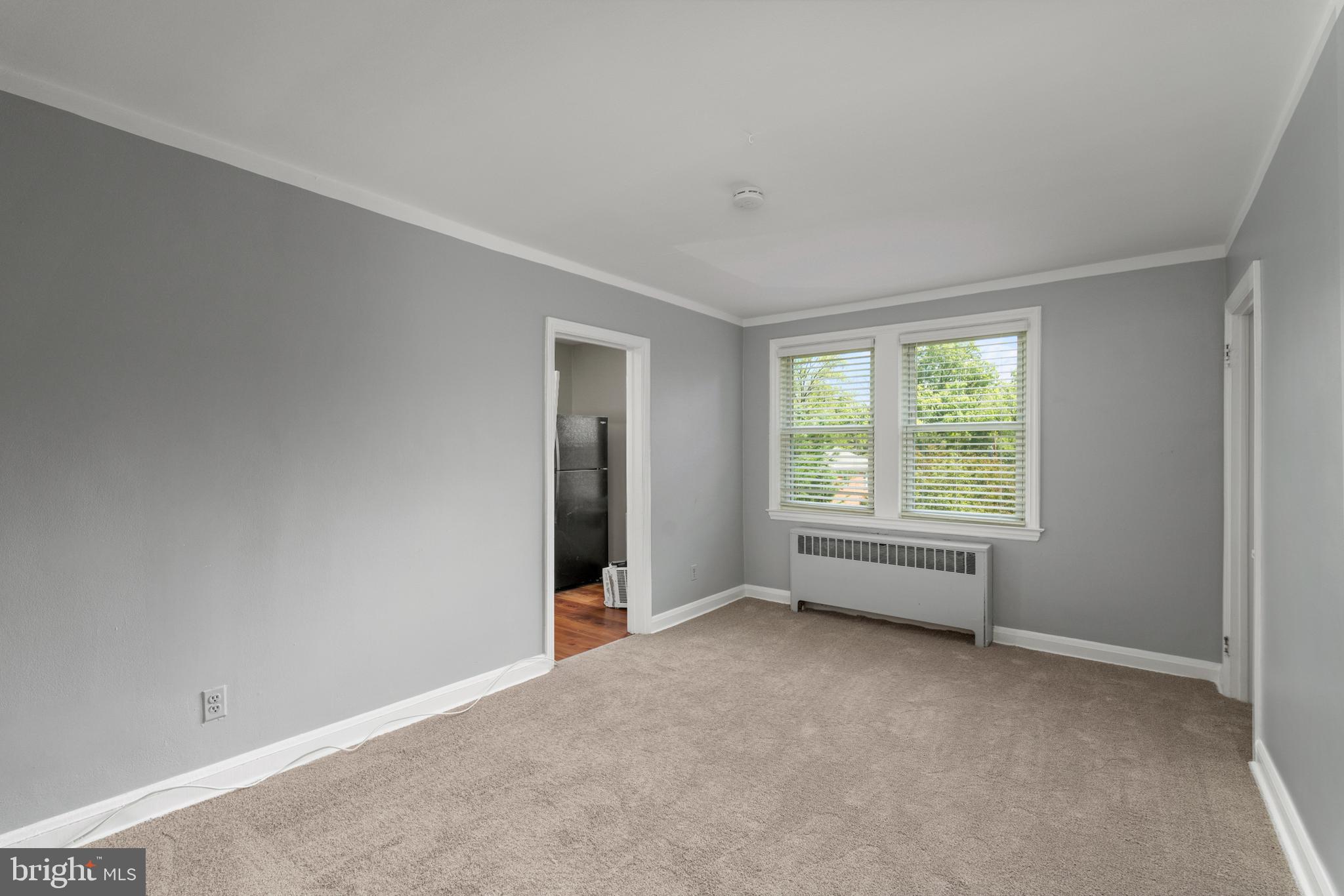 5708 Rockspring Road, Unit B Baltimore, MD 21209 - Photo 4 of 19 an empty room with windows