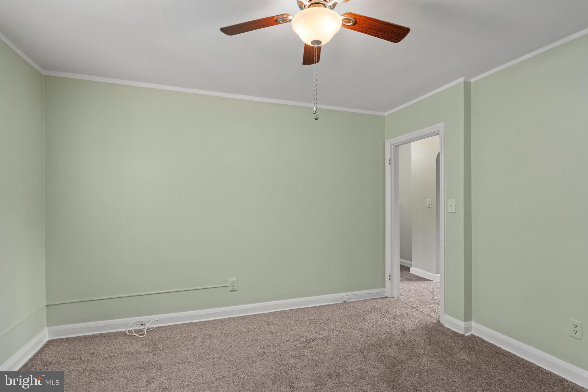 5708 Rockspring Road, Unit B Baltimore, MD 21209 - Photo 8 of 19 an empty room with a chandelier fan