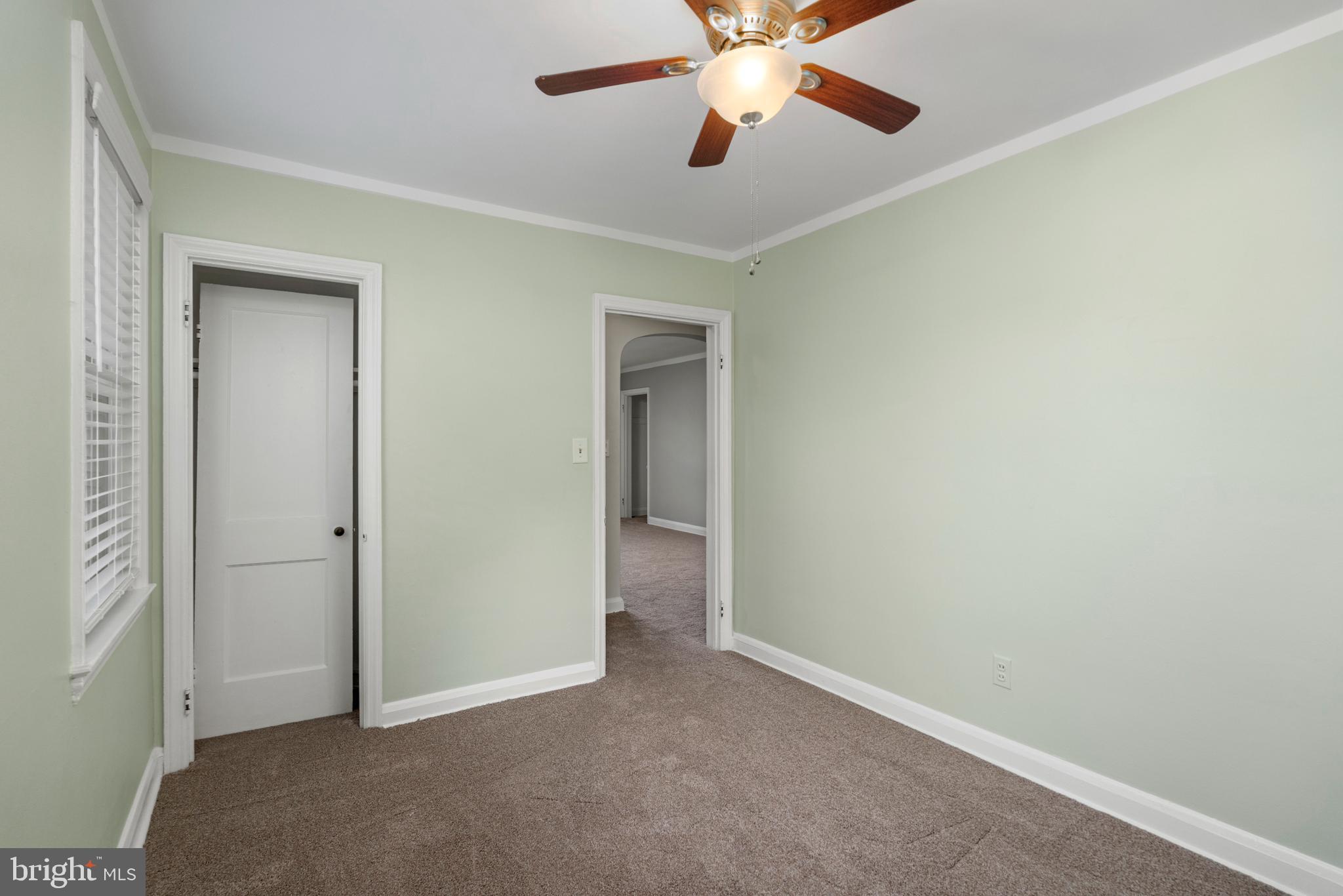 5708 Rockspring Road, Unit B Baltimore, MD 21209 - Photo 10 of 19 an empty room with closet and a chandelier fan