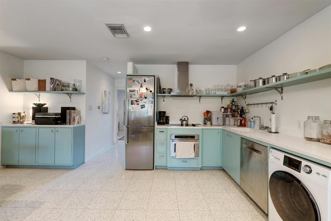 a kitchen with cabinets and stainless steel appliances