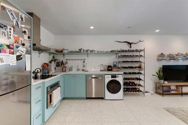 a kitchen with a sink a stove and cabinets