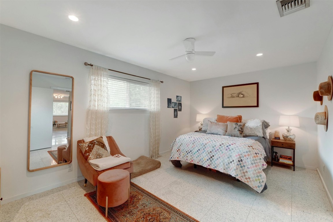 1208 Enfield Road, Unit 202 Austin, TX 78703 - Photo 12 of 19 a bedroom with a bed and a chandelier