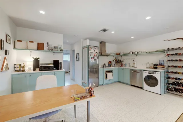 a kitchen with refrigerator and cabinets