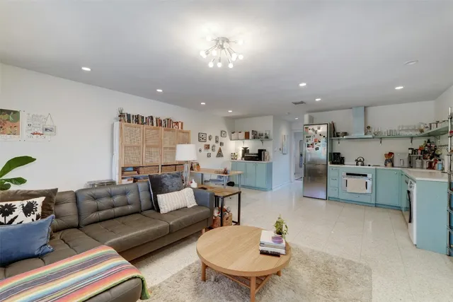 a living room with furniture and kitchen view