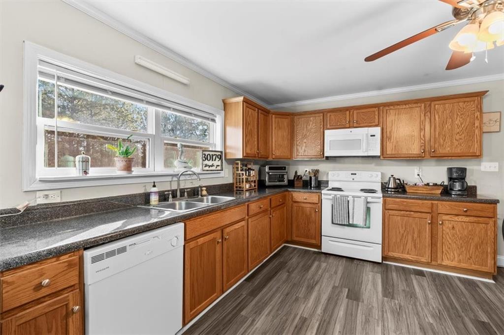 718 Baskin Road Temple, GA 30179 - Photo 12 of 50 a kitchen with stainless steel appliances granite countertop wooden cabinets a sink and a stove