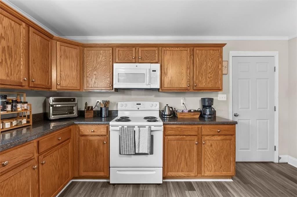 718 Baskin Road Temple, GA 30179 - Photo 14 of 50 a kitchen with stainless steel appliances granite countertop a stove a sink and white cabinets