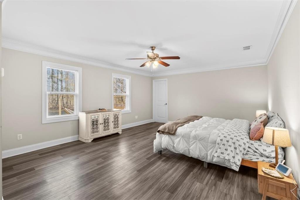 718 Baskin Road Temple, GA 30179 - Photo 17 of 50 a bedroom with a bed and wooden floor