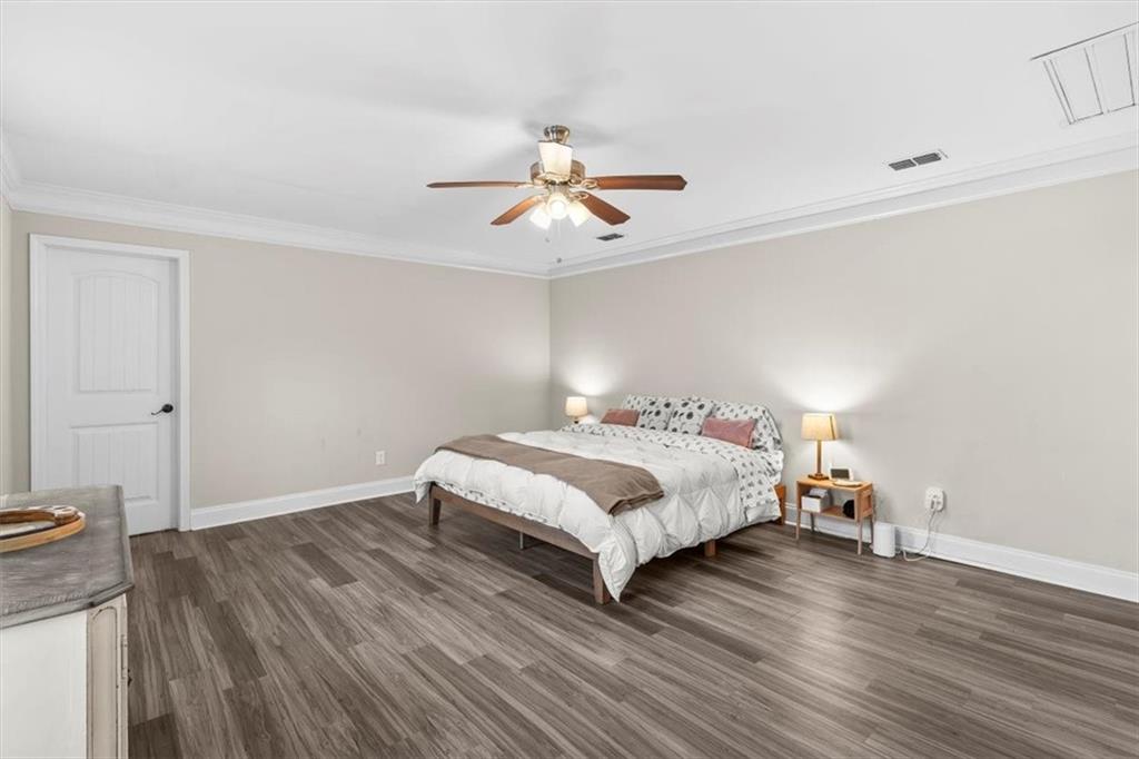 718 Baskin Road Temple, GA 30179 - Photo 18 of 50 a bedroom with a bed and wooden floor