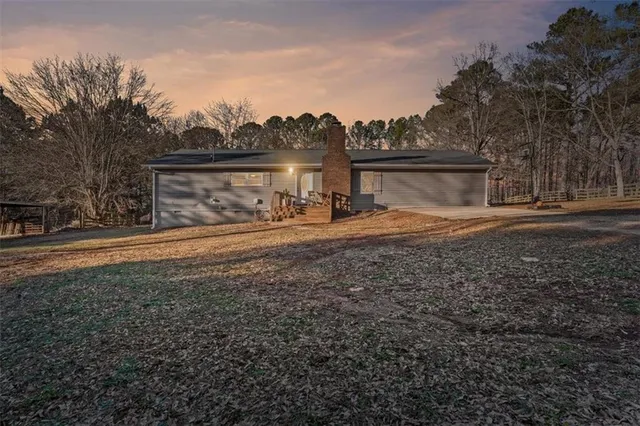 a view of dirt yard with a large tree