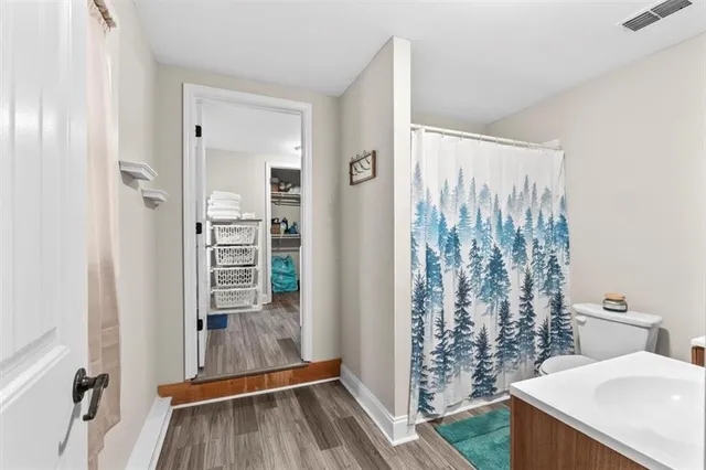 a view of a bathroom with tub and shower