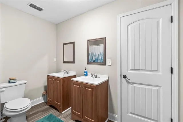 a bathroom with a toilet a sink and mirror