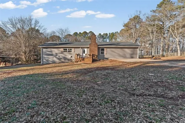 a view of dirt yard with a large tree