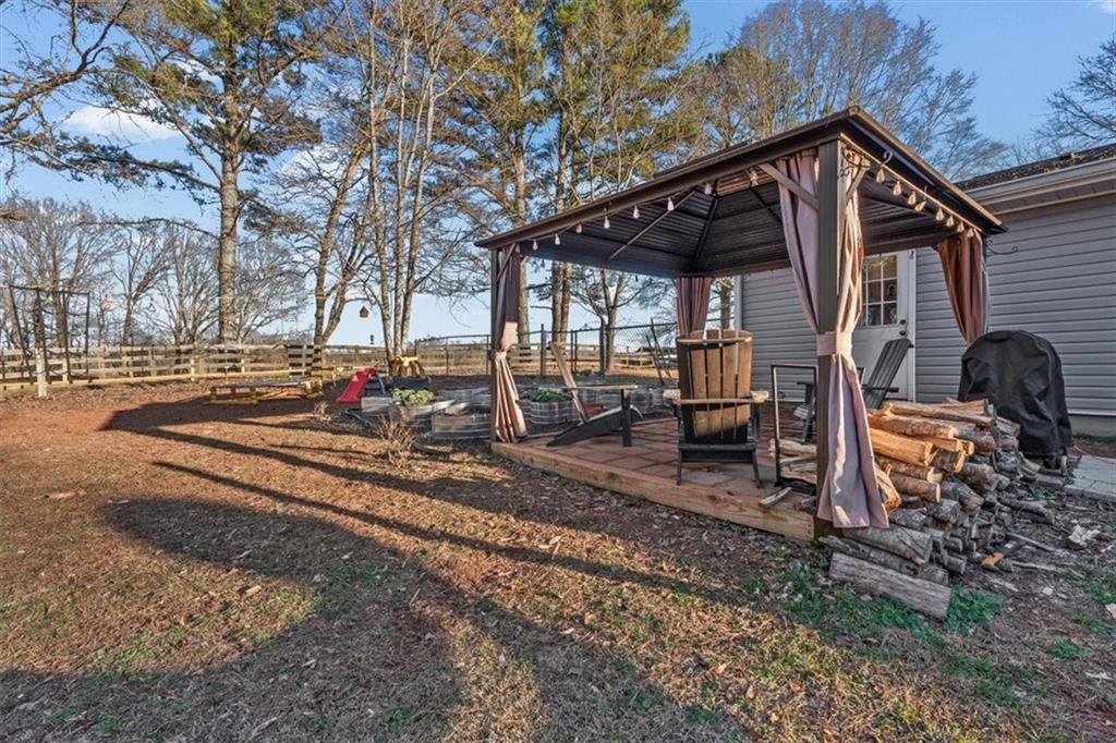 718 Baskin Road Temple, GA 30179 - Photo 33 of 50 a view of a house with backyard and trees