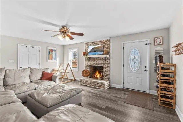 a living room with furniture a clock and a fireplace