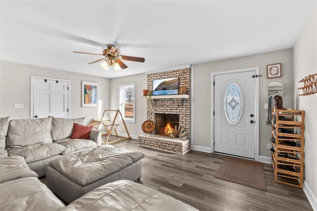 718 Baskin Road Temple, GA 30179 - Photo 6 of 50 a living room with furniture a clock and a fireplace