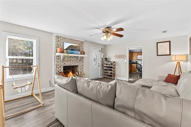 a living room with furniture a fireplace and a flat screen tv