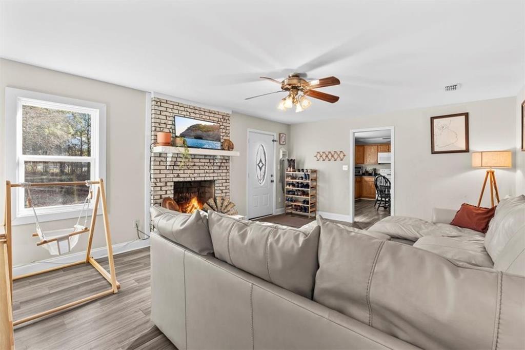 718 Baskin Road Temple, GA 30179 - Photo 7 of 50 a living room with furniture a fireplace and a flat screen tv