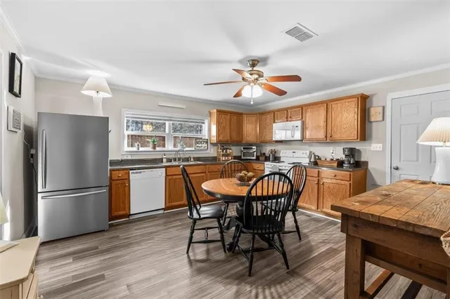 a view of a dining room with furniture window and wooden floor