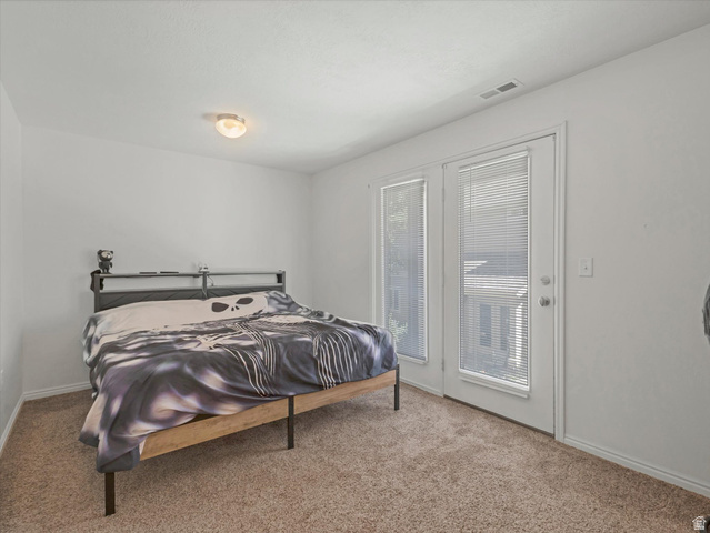5038 West Red Shale Road Herriman, UT 84096 - Photo 12 of 16 Carpeted room featuring a ceiling-mounted light fixture and dual glass-paneled doors with blinds