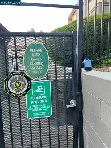 a view of a house with large windows and a small yard