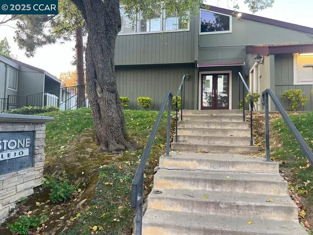 a bedroom with a bed and a couch with window