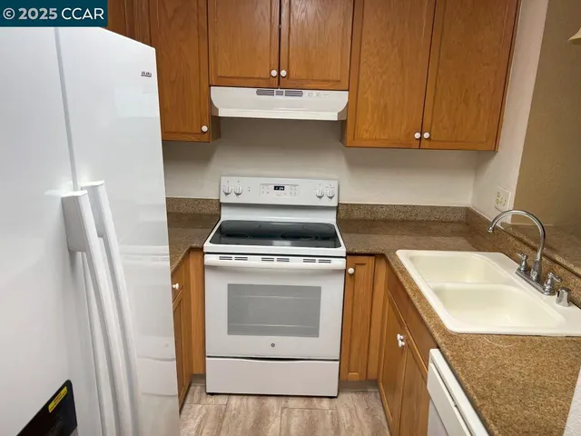 a kitchen with a refrigerator and a sink