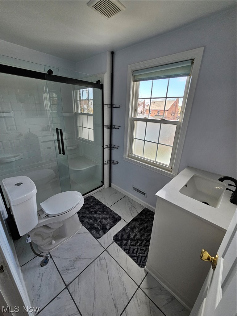 3688 Rolliston Road Cleveland, OH 44120 - Photo 29 of 44 Bathroom featuring vanity, toilet, tile flooring, and an enclosed shower