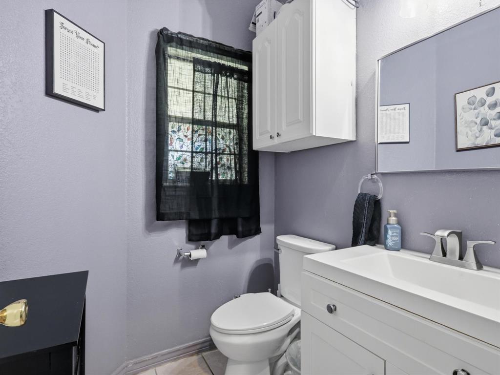 130 Parsonage Street Azle, TX 76020 - Photo 21 of 39 Half bathroom with vanity and light tile patterned floors