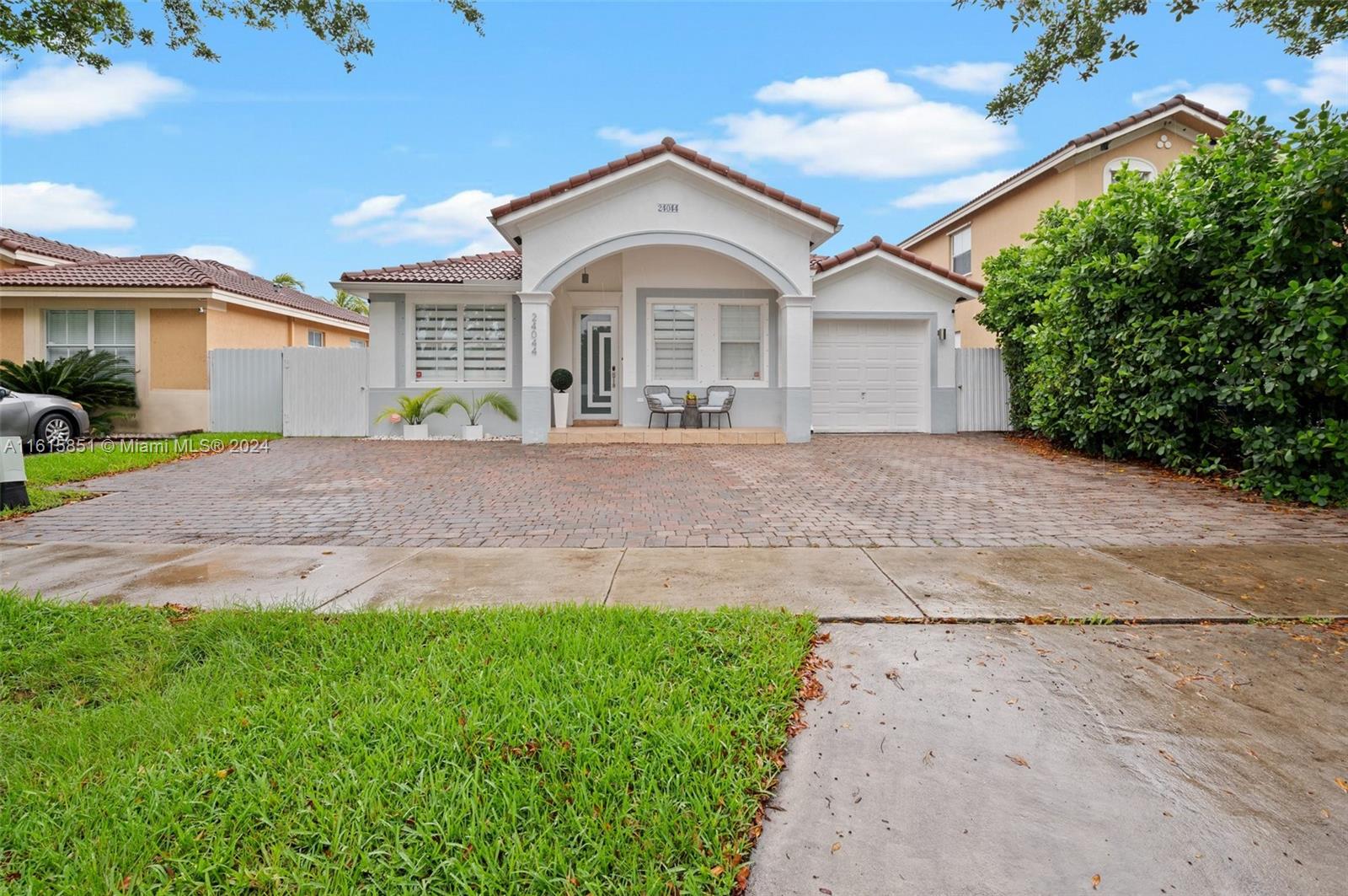 a front view of a house with a yard and garage