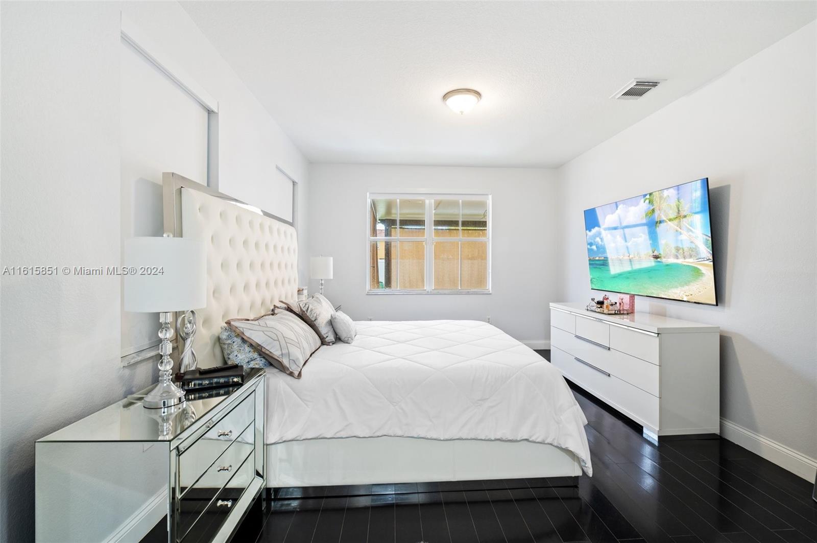 24044 Southwest 107th Court Homestead, FL 33032 - Photo 12 of 26 a bedroom with a bed and a dresser